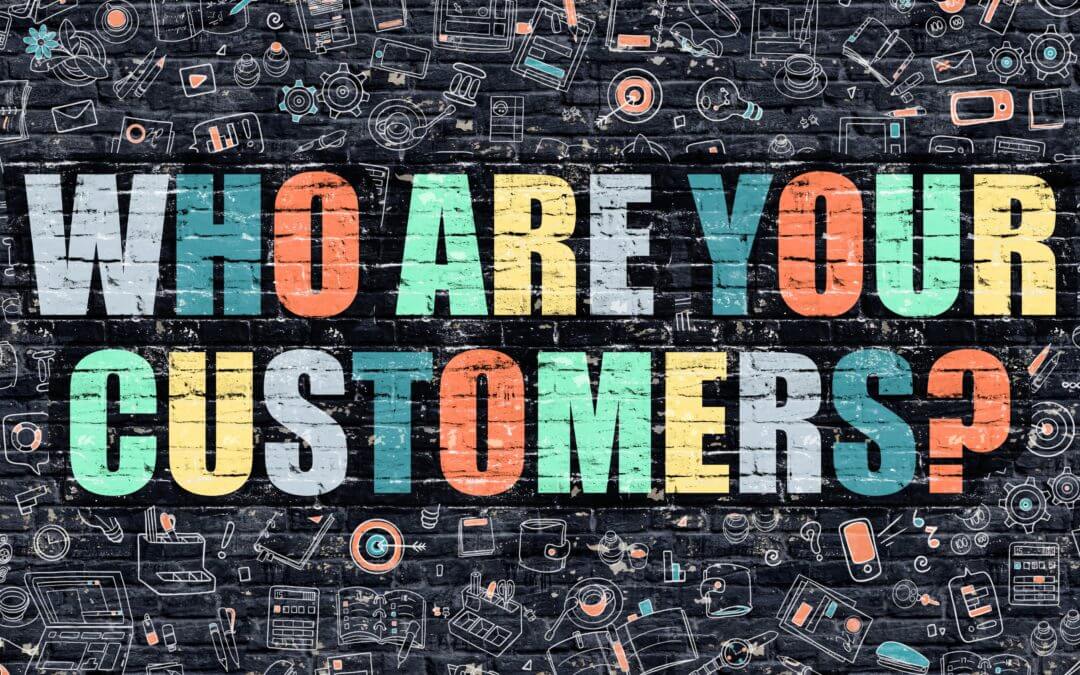 wall of graffiti with "Who Are You Customers?"